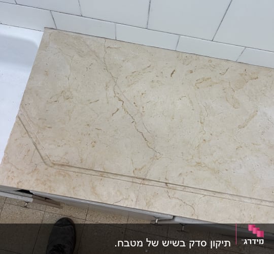 משטח שיש סדוק ושבור עם חריץ ניקוז לפני תיקון